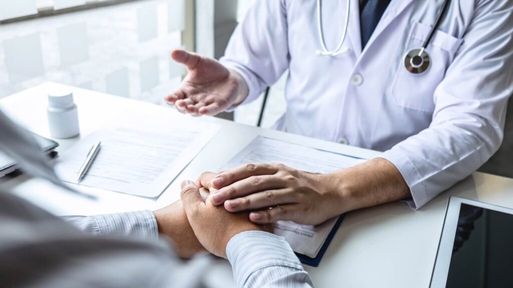 doctor holding patient's hand